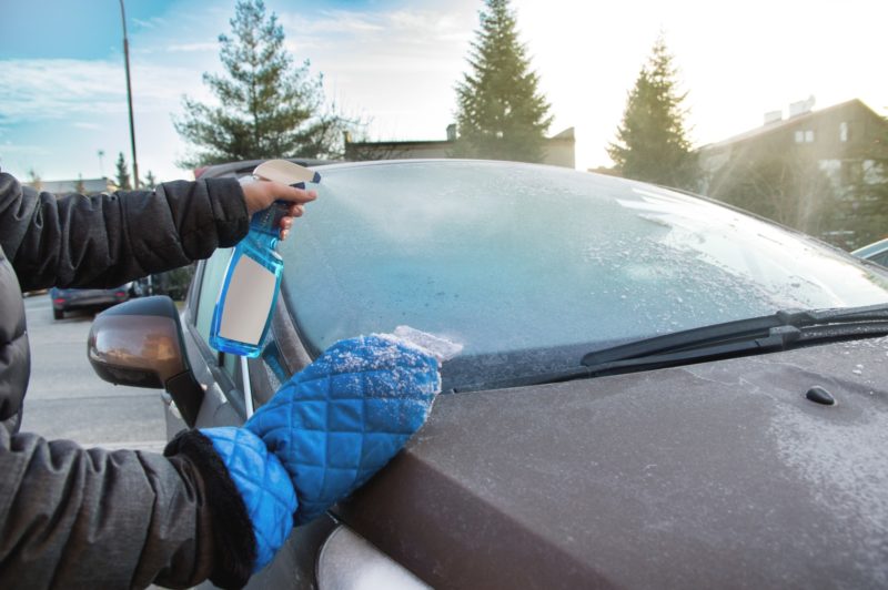 Defroster spray to remove frost from the car windshield